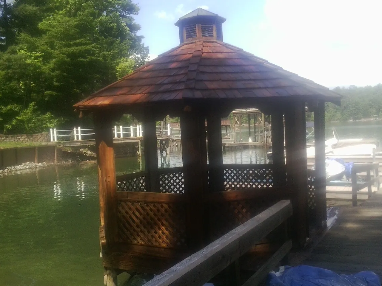 Cedar shake gazebo roof rebuilt on a lake dock in Churubusco