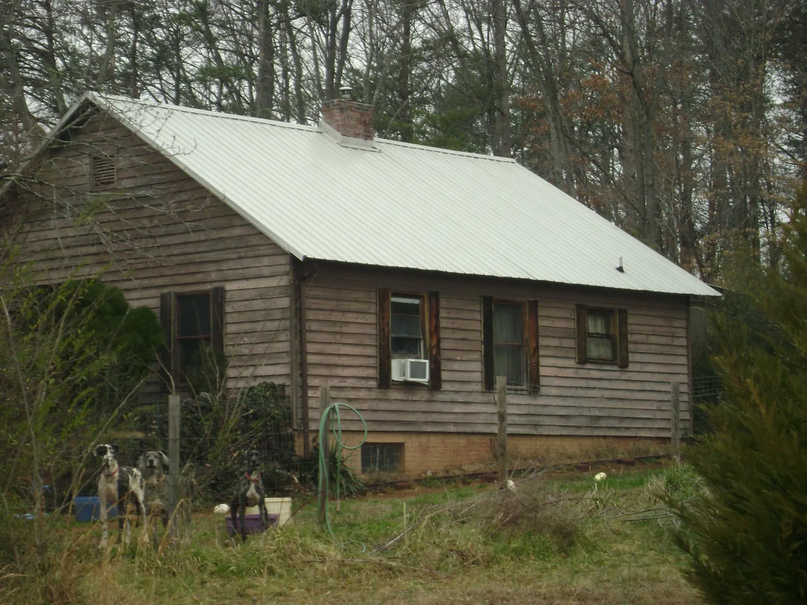 White metal roof on an old wood sided farmhouse, from a Metal Roof Installation job in Churubusco